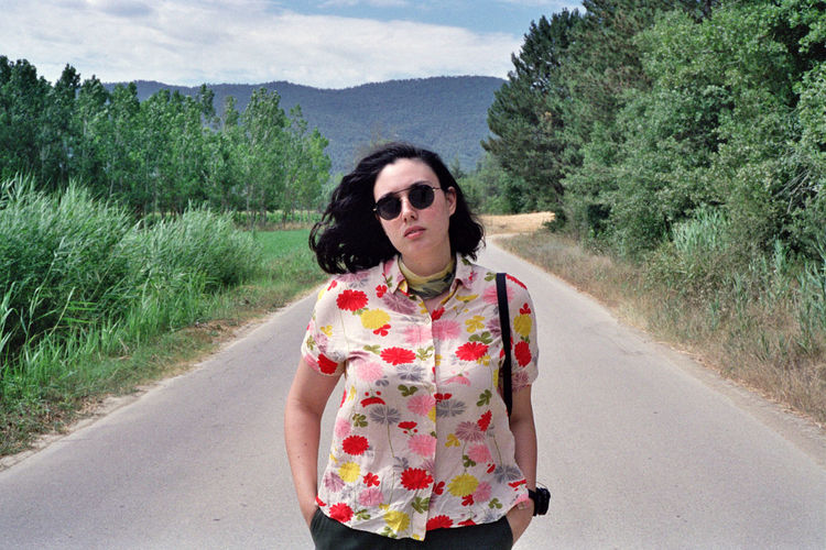 Portrait of woman with sunglasses on road