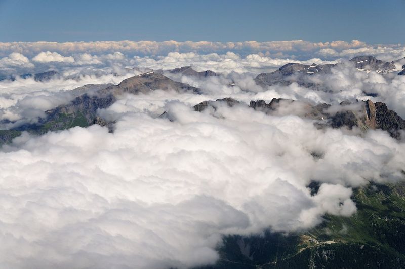 Scenic view of clouds covering mountains against sky