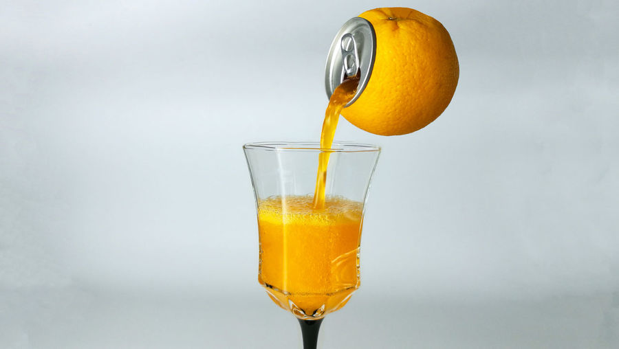 Close-up of drink against orange glass