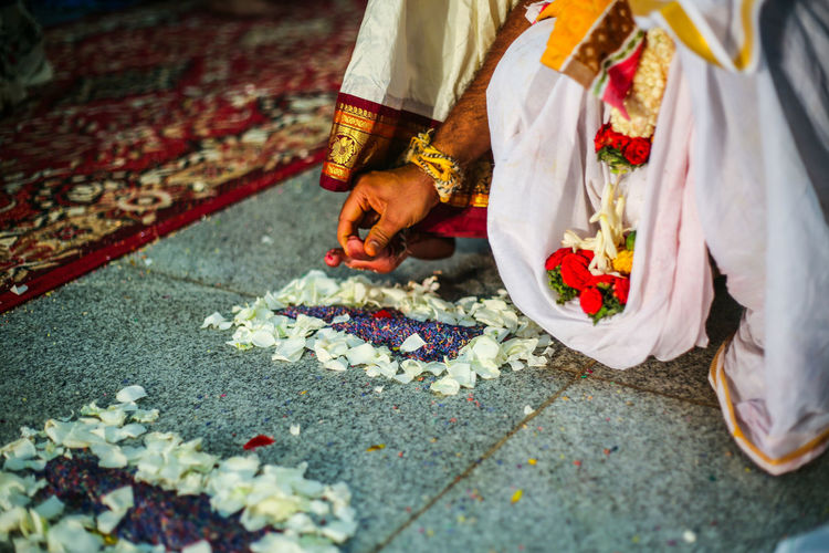 Low section of couple performing rituals during wedding ceremony