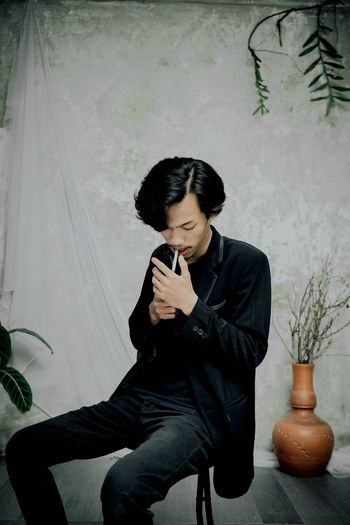 Young man using still cigarettes in hand