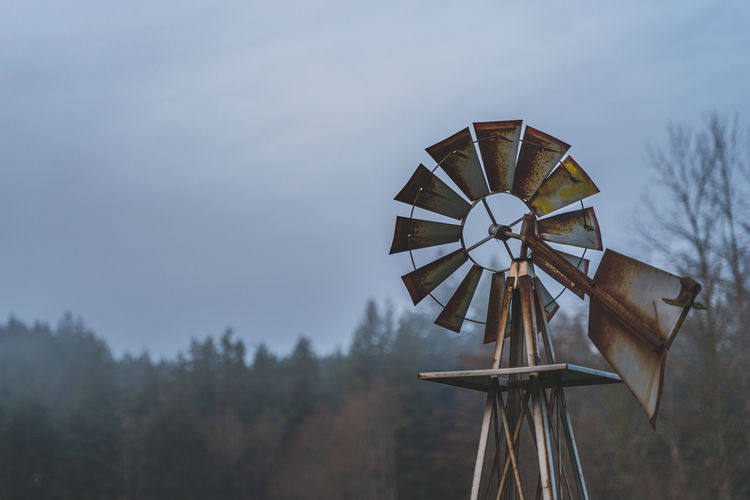 Low angle view of windmill against sky