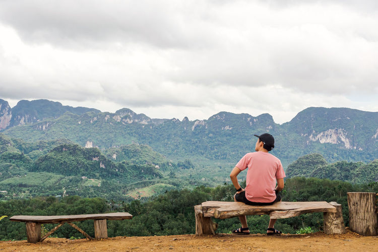 Solo traveller enjoying beautiful nature of hills and during rainy season at doi tapang