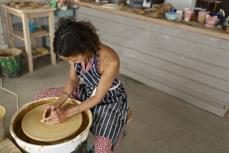 Woman using potters wheel