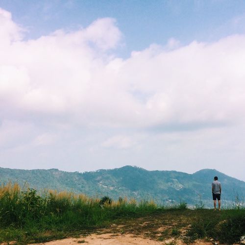 Scenic view of landscape against cloudy sky