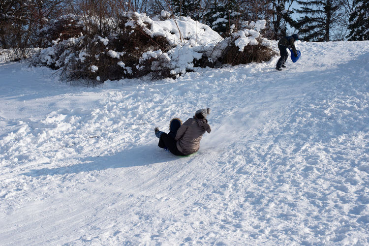 High angle view of woman sliding on snow