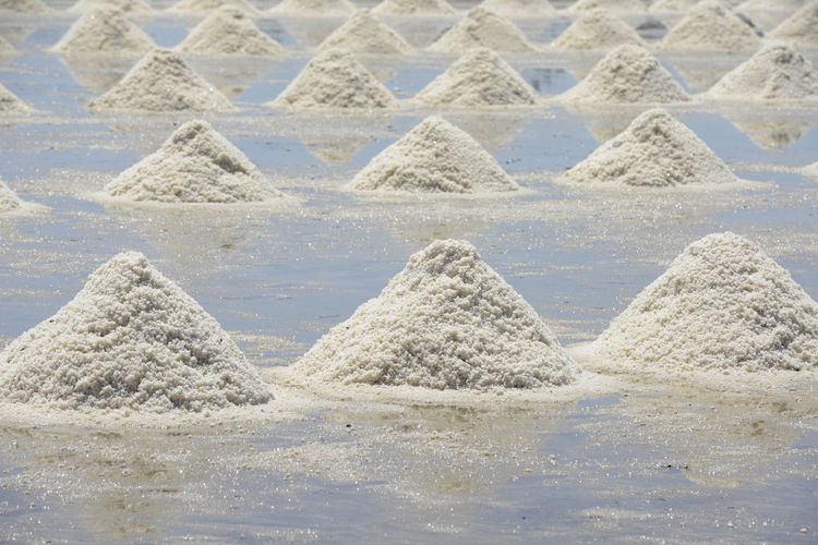 Salt heaps during sunny day