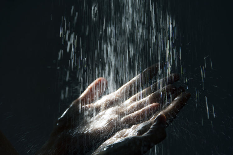 Close-up of water falling on hands