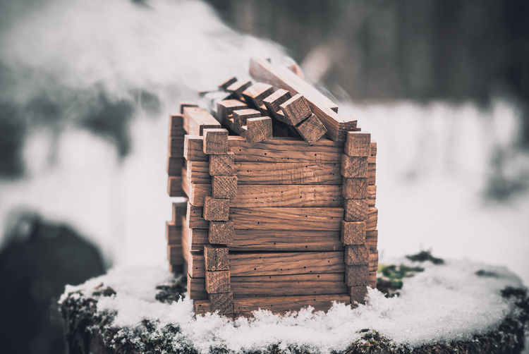 Stack of logs on snow covered field