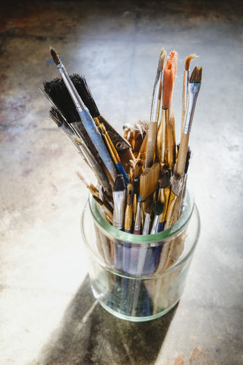 High angle view of paintbrushes in jar on table