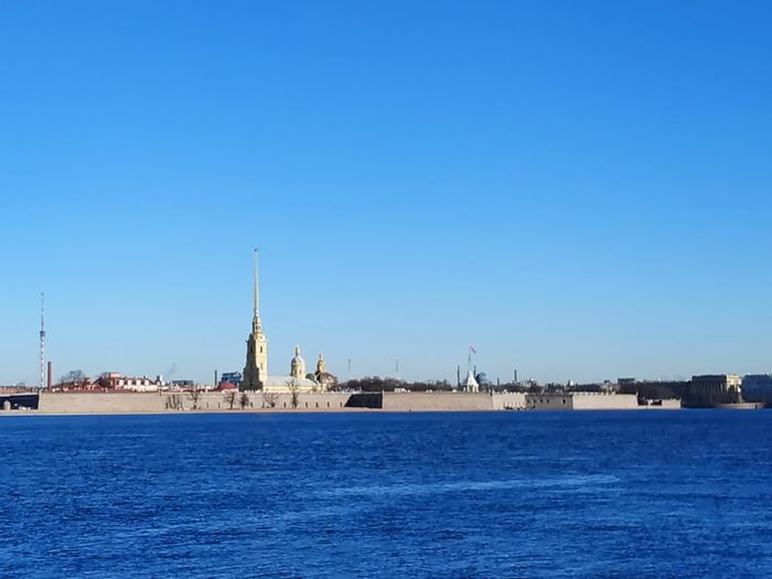 Scenic view of neva river against clear blue sky