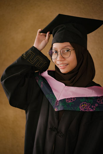 Portrait of woman wearing graduation gown