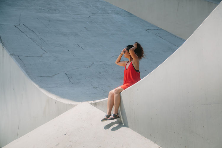 Full length of woman standing by railing