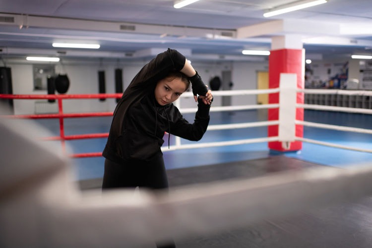 Strong fighter preparing for sparring on ring