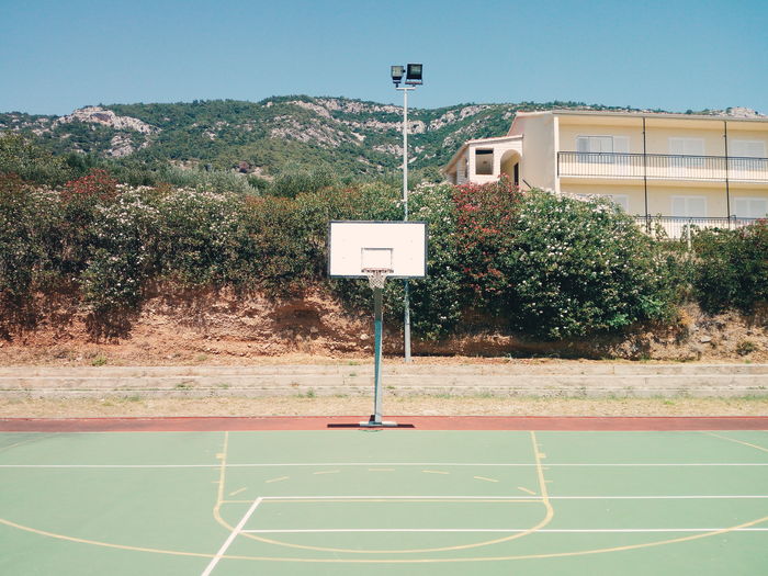 Basketball court against plants