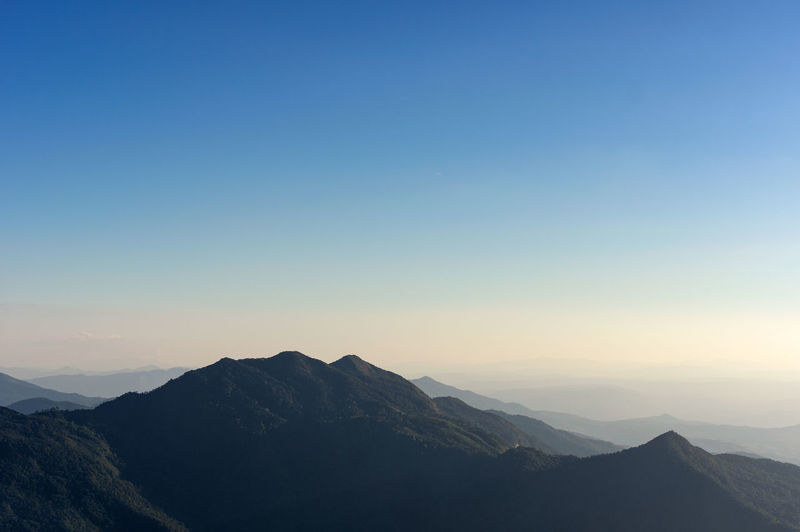 Scenic view of silhouette mountains against clear sky