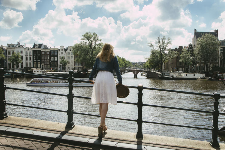 Woman looking over city canal