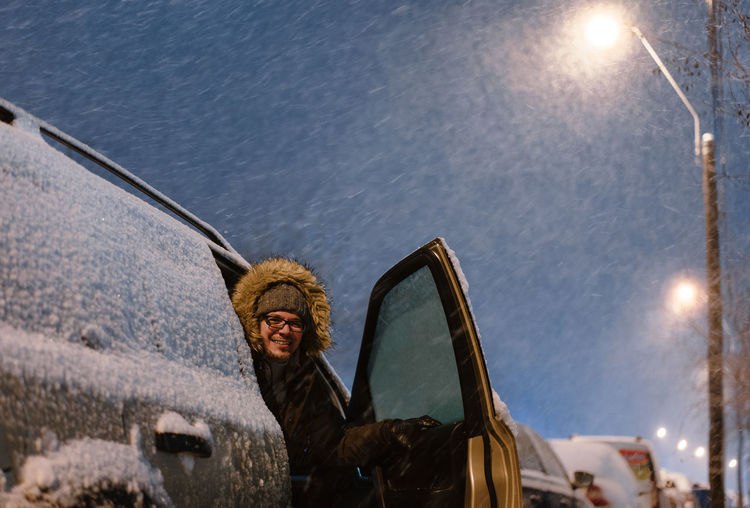 Portrait of man in car in winter blizzard