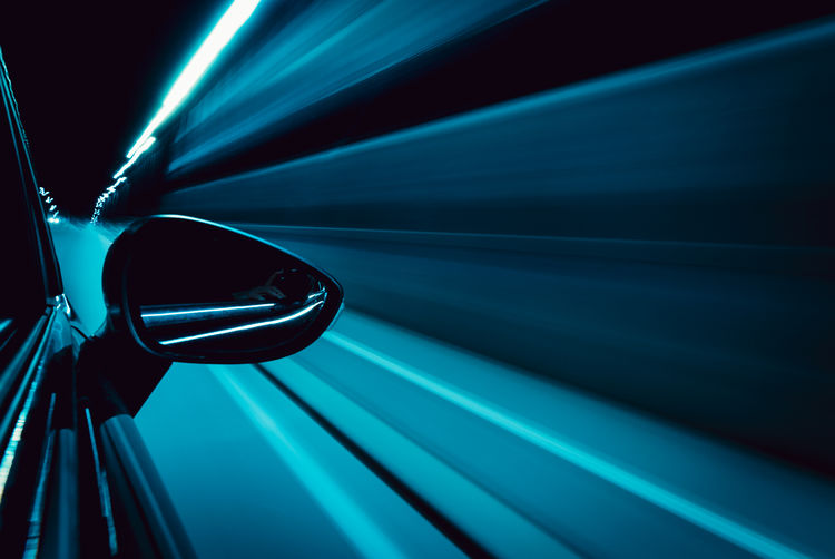 Cropped image of car moving on road at night