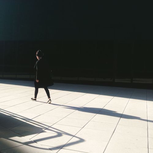 Full length of woman standing by railing
