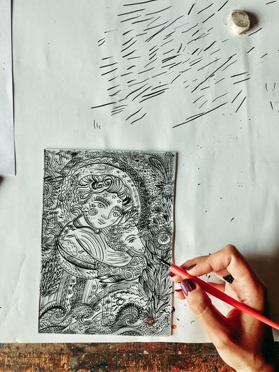 High angle view of hand painting on paper