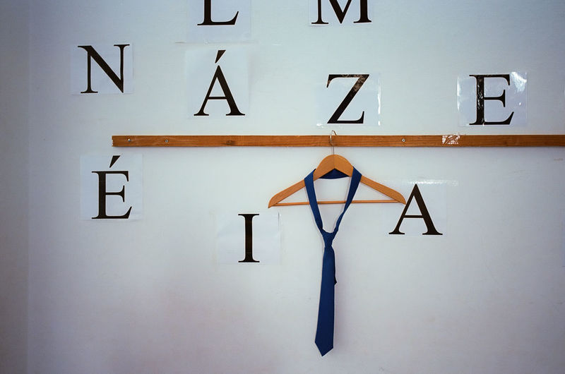 Close-up of a tie on wall after school graduation