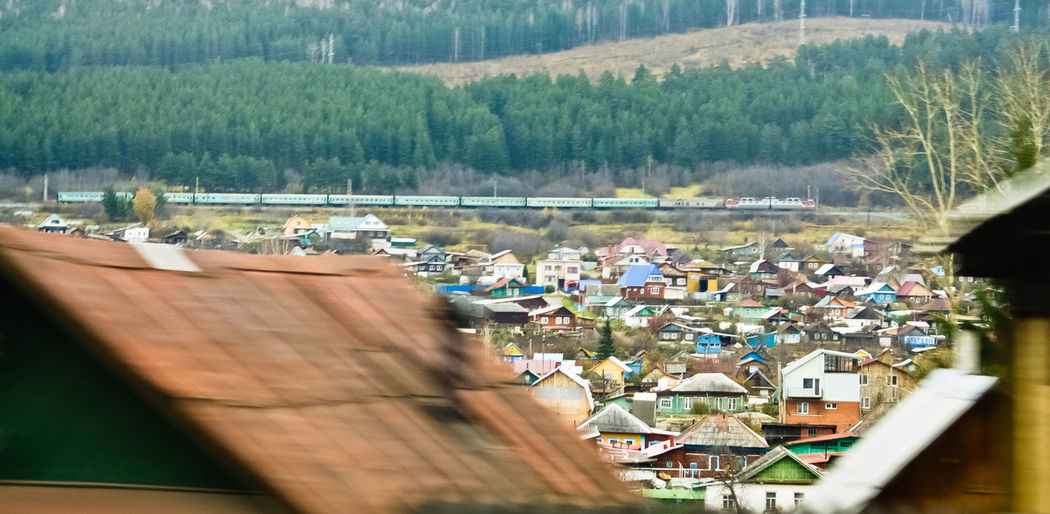 View of village houses and train passing at distant 