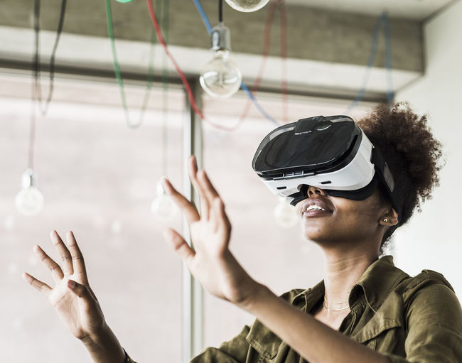Woman in office using virtual reality glasses