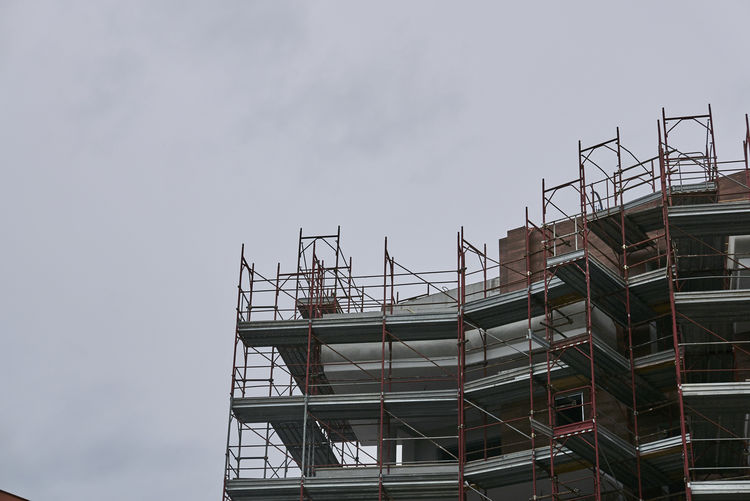 Low angle view of construction site against sky