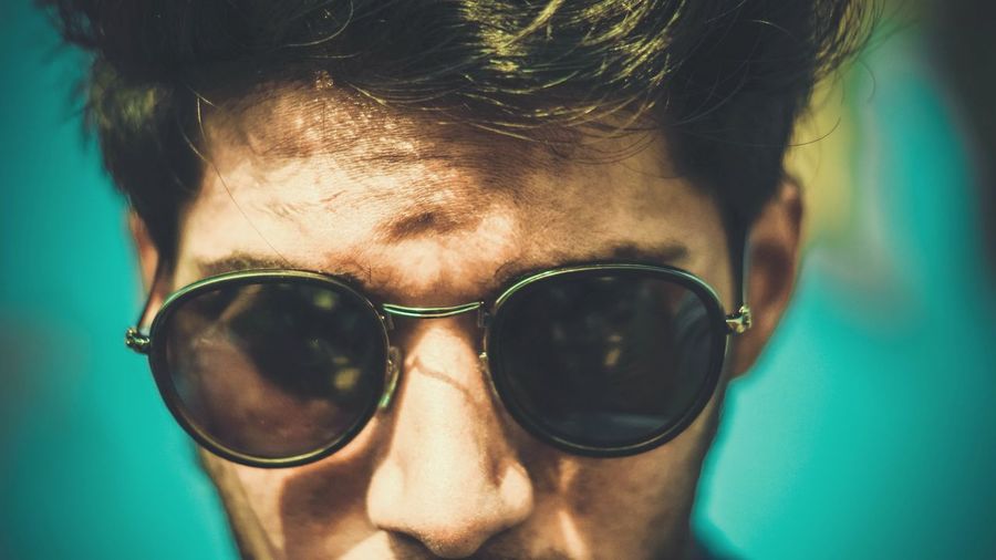 Close-up portrait of man in sunglasses on sunny day