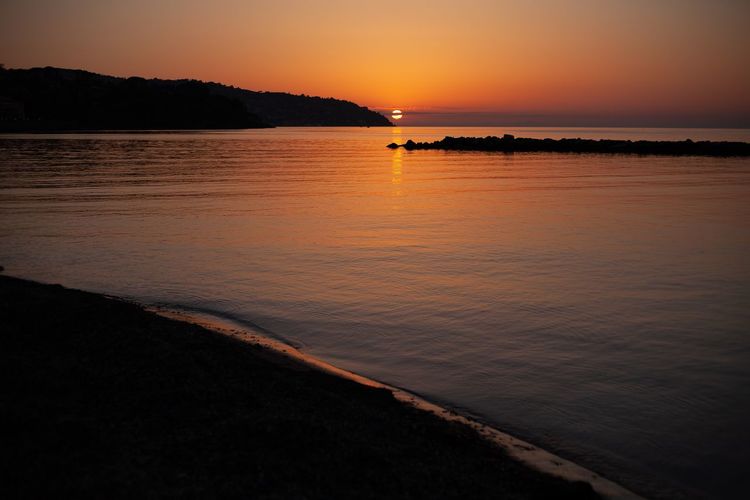 Scenic view of sea against sky during sunset
