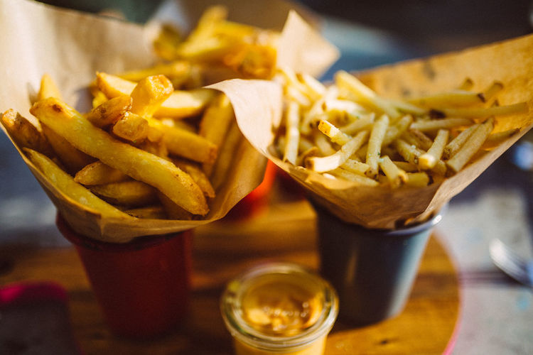 Close-up of french fries served on table.