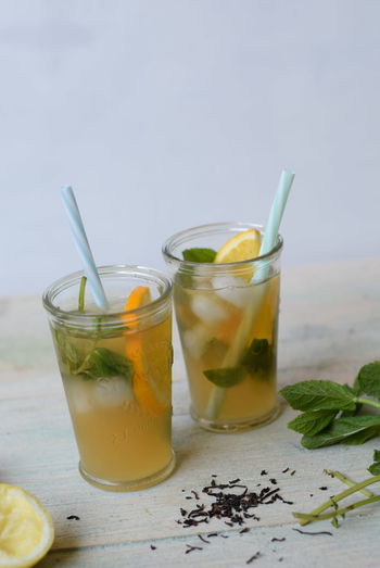 View of glasses of iced tea with mint and sliced lemon