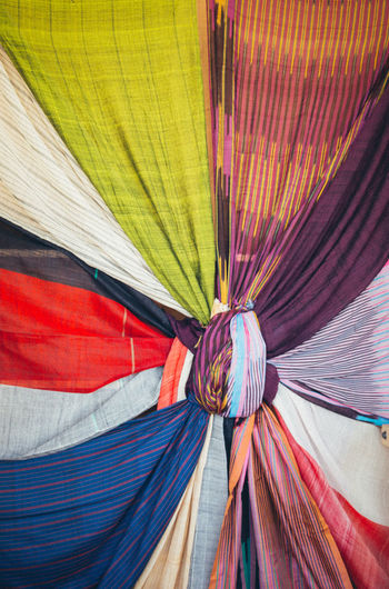 Low angle view of multi colored textiles tied up