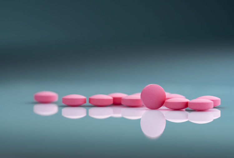 Close-up of pills over turquoise background