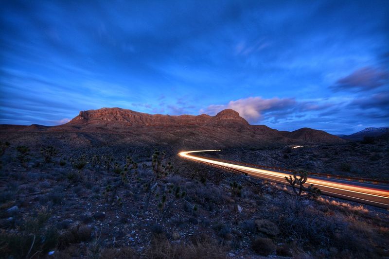 High angle view of light trails on mountain road against sky