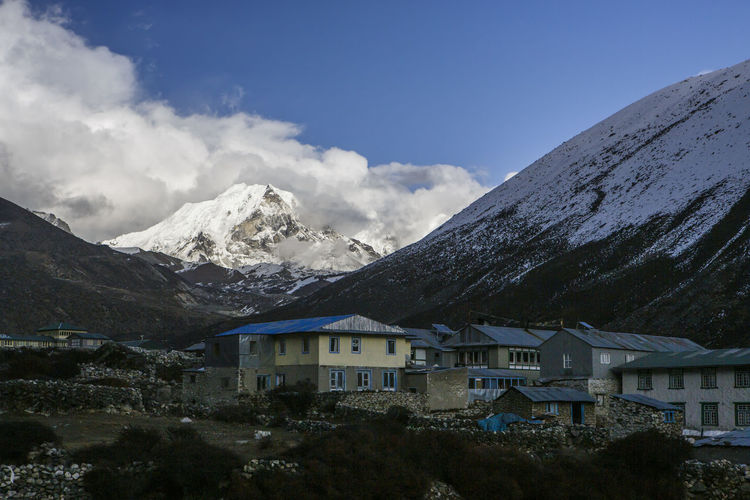 Buildings against mountains during winter