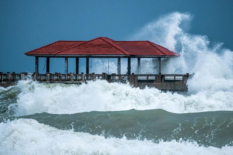 Lifeguard hut on sea shore against sky