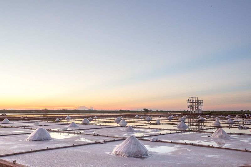 Salt evaporation pond against sky