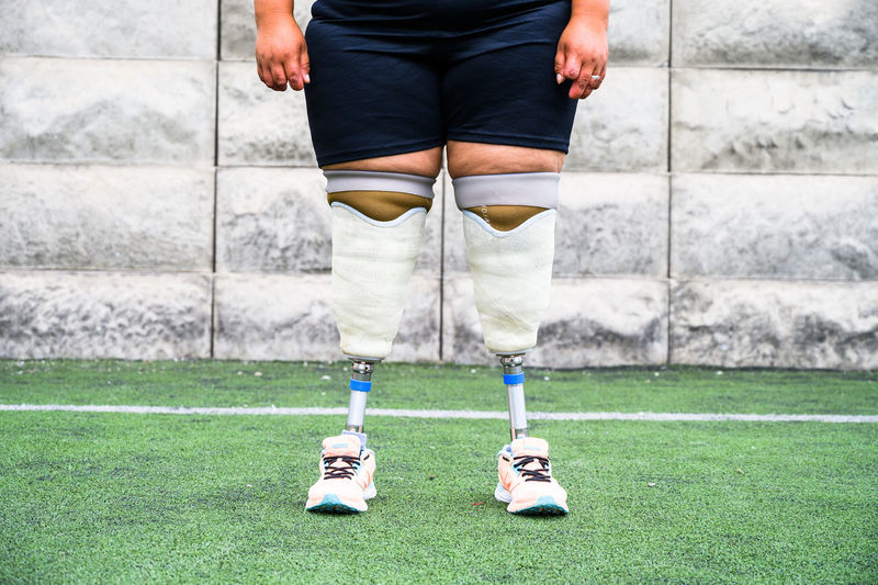 Unrecognizable female athlete with prosthetic legs