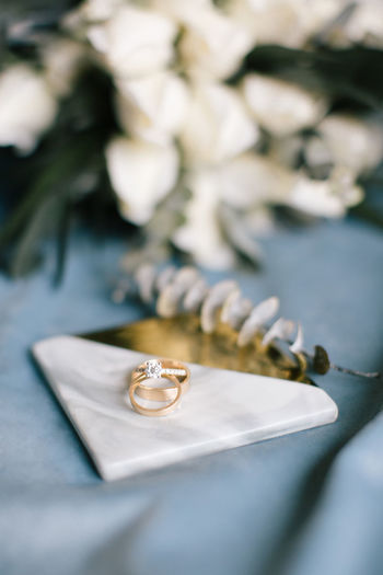 CLOSE-UP OF WEDDING RINGS ON TABLE WITH METAL