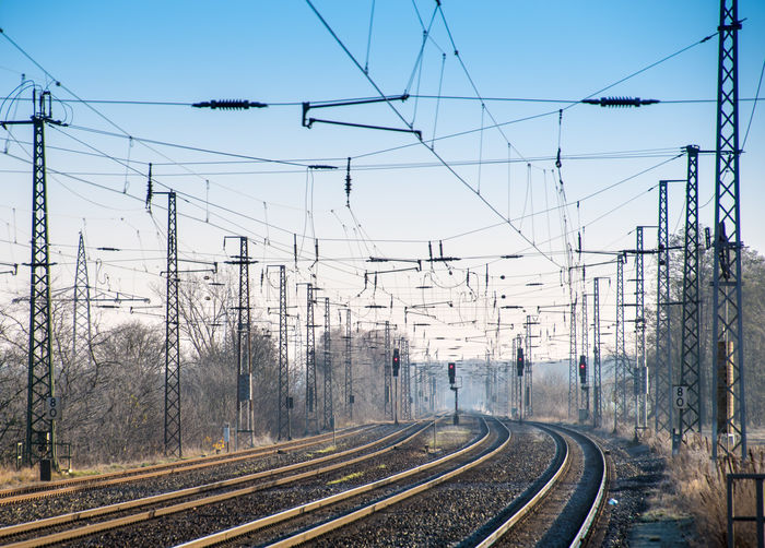 Railway tracks against clear sky during winter