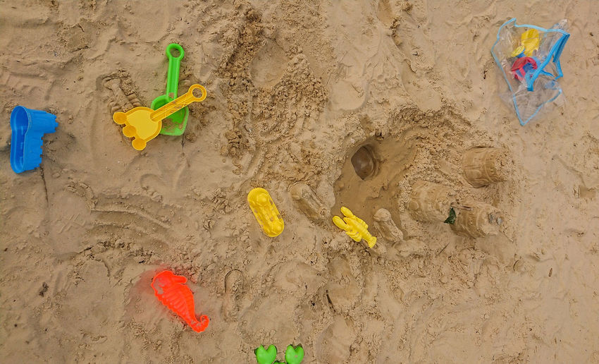 High angle view of yellow toy on beach