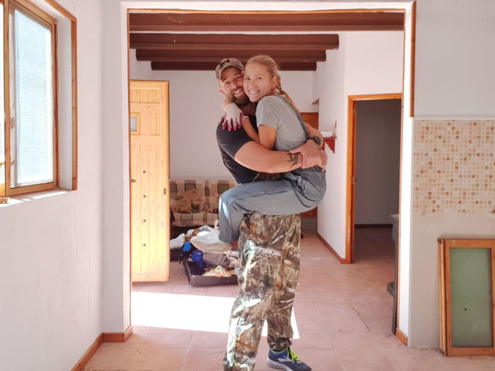Couple just moved in in the new house hugging each other