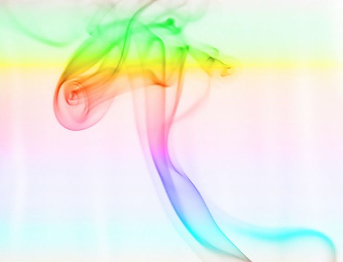 Close-up of colorful smoke against white background