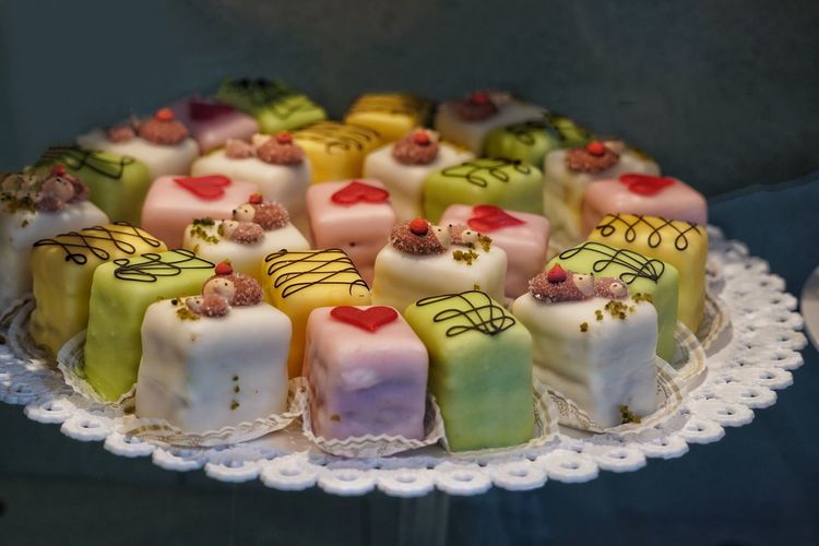 High angle view of decorated small cakes on plate