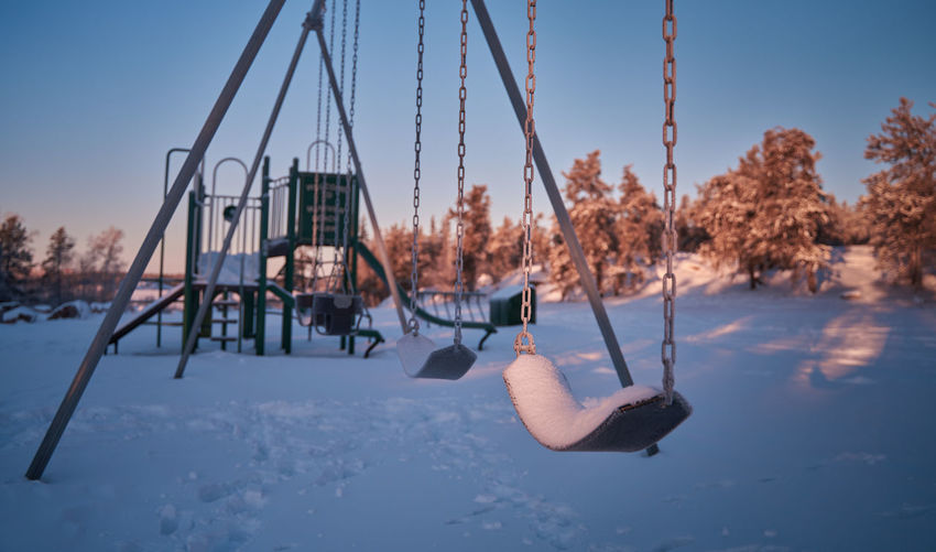 Swing covered with snow