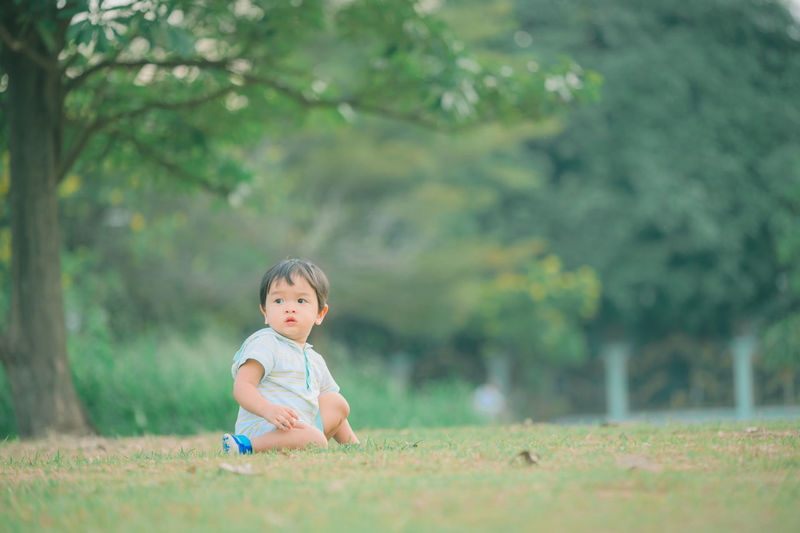 Full length of cute baby girl on field