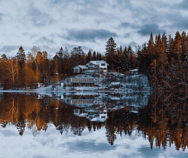 Reflection of great house in lake around the forest