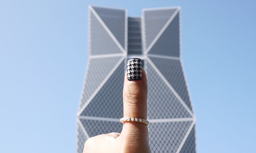 Cropped image of woman hand with nail art against china steel